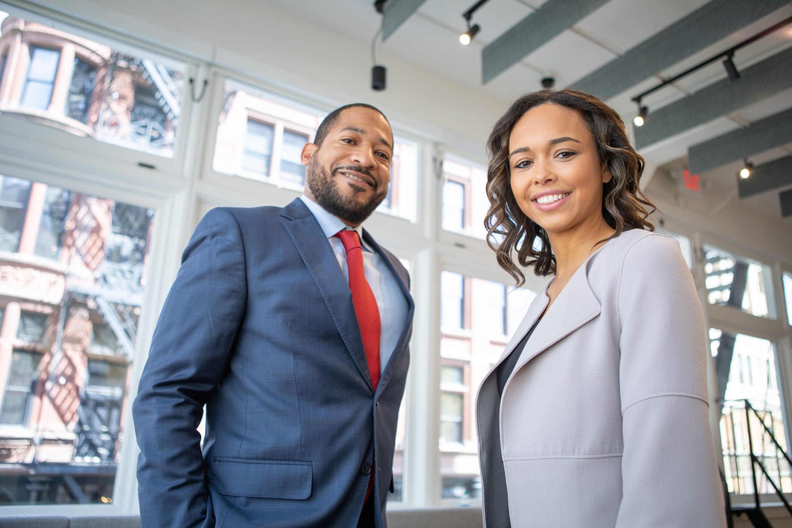 Man and woman smiling inside building
